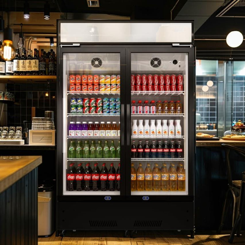 A two-section swing glass door commercial merchandiser refrigerator with drinks and beverages on shelves in the restaurant scene